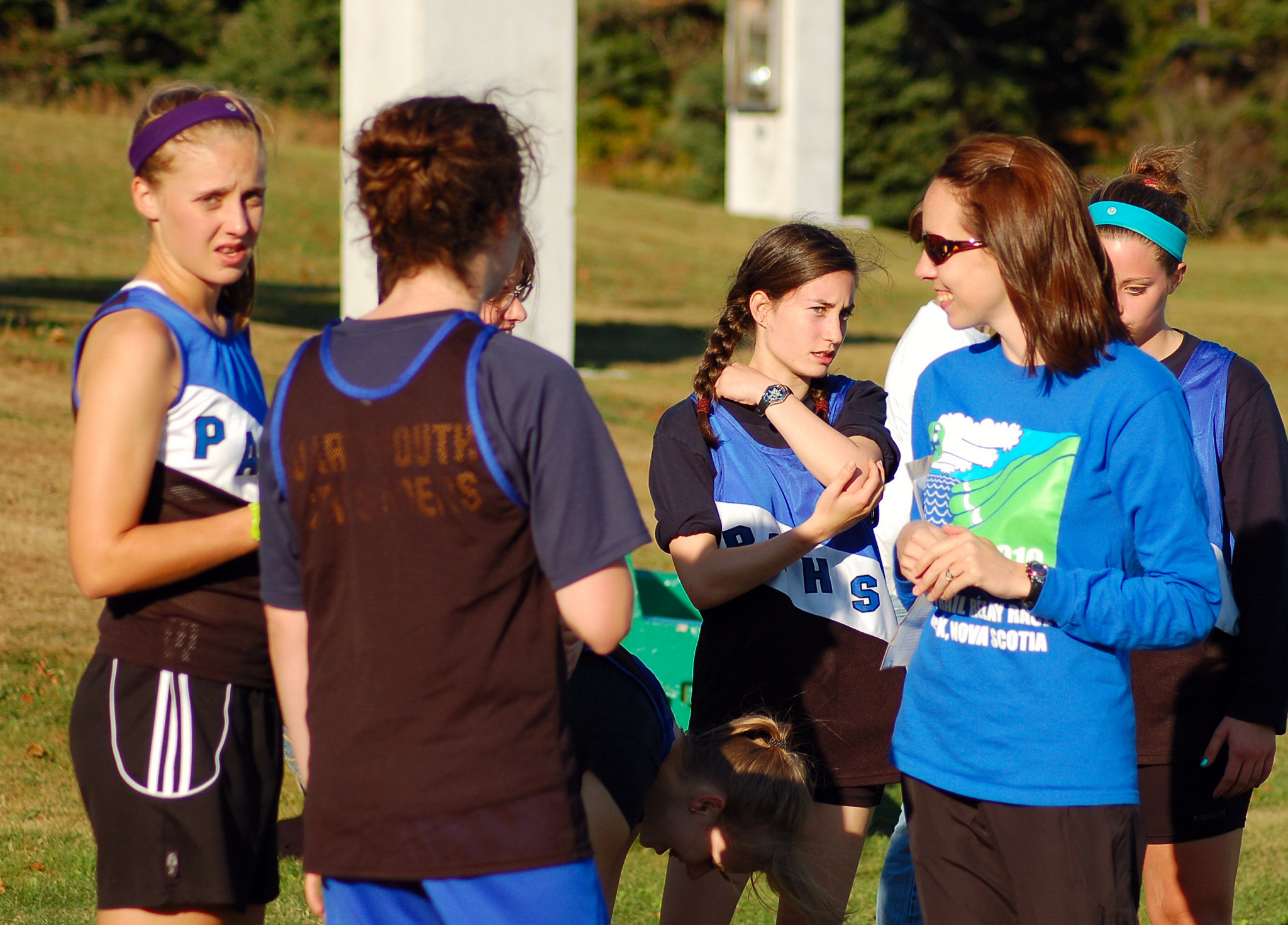 high school cross country coach talks to her athletes