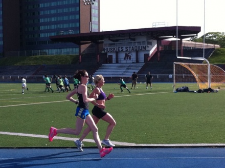 two runners train at SMU track