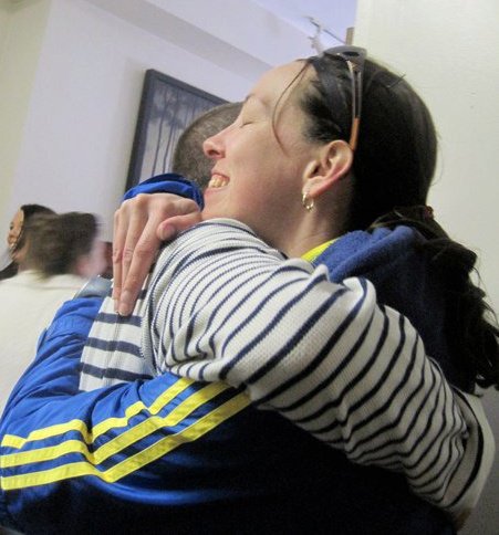 husband and wife embrace after Boston Marathon 2011