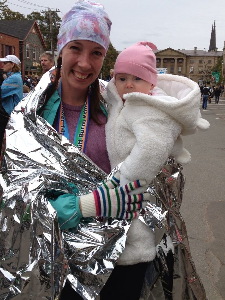 Mother runner and baby at race finish line